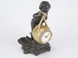 a statue of a woman holding a clock on top of a rock