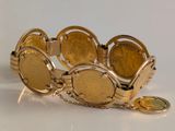 bracelet made of gold coins with a coin charm attached to it