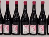 six bottles of wine are lined up on a table