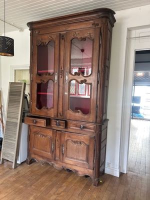 a large wooden cabinet in the middle of a room