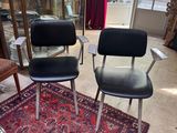 two chairs in a room with a rug on the floor