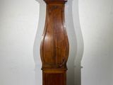 a tall wooden grandfather clock in the corner of a room