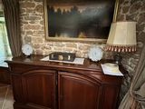 a picture of a living room with a stone wall