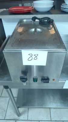 a stainless steel counter top with a hot pot on it
