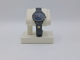 an image of a watch on a stand on a white surface