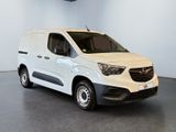 the white van is parked in a large room with a ceiling fan