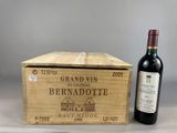 a wooden box with a bottle of wine next to it