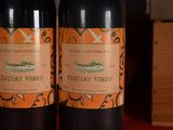 two bottles of wine sitting next to each other on a table
