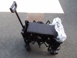 a black cart with a black seat and a black bag on it