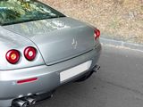 a silver sports car parked on the side of the road