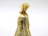 a statue of a woman in a yellow dress and a hat