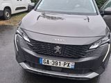 a grey car parked in a parking lot next to other cars