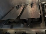 three pans that are on the stove in the kitchen
