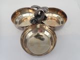 a silver plate with a bird on top of it