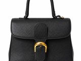 a black leather handbag with a gold buckle
