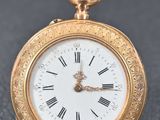 an image of a gold pocket watch with roman numerals on the face