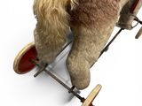 a toy horse that is sitting on top of a skateboard