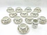 a lot of cups and saucers sitting on a table