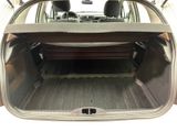 the back of a car with a bench in the trunk of it