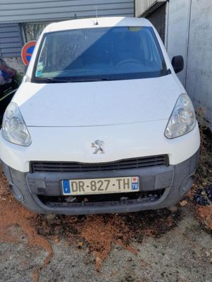 a small white car parked in front of a building