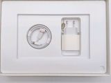 a white box with a charger and a cable in it