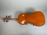 an old violin sitting on top of a table next to a wall
