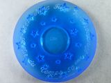 a blue glass plate with writing on it on a table
