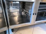 two ovens that are open in the kitchen