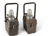 two small metal containers with a light on top of them