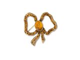 une image représentant une broche en forme de nœud jaune et marron sur fond blanc