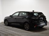 the back end of a black car parked in a garage