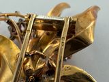 a close up of a gold brooch with a horse on it