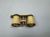 an old pair of binoculars sitting on top of a white table