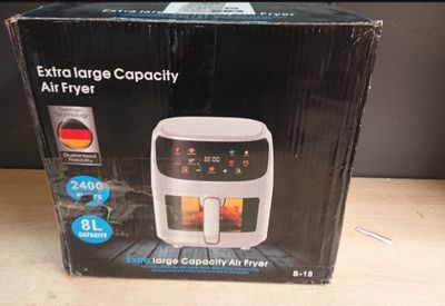 boxed box of a large air fryer sitting on a wooden table