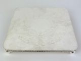 a silver laptop computer sitting on a white surface