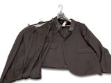 a suit and tie on a hanger on a white background