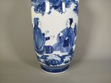 a blue and white vase with a picture of a man and a woman on it