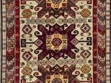 a red and beige rug with a pattern on it