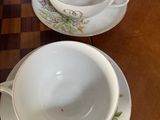three cups and saucers sitting on a wooden table