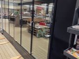 a picture of an empty grocery store with the doors open