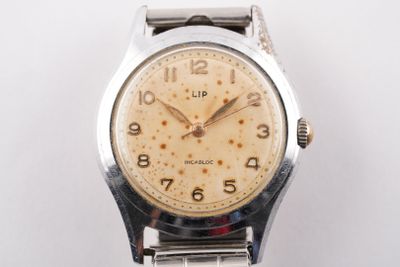 une image d'un gros plan d'une montre-bracelet sur une surface blanche