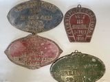 three old metal signs are hanging on a wall in a room