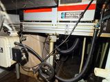an image of a machine that is working on a piece of metal