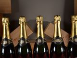 six bottles of champagne are lined up in a row on a table