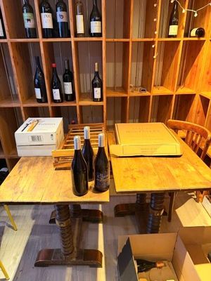 des bouteilles de vin et des cartons posés sur une table dans une cave à vin
