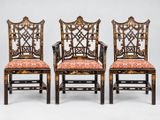 un ensemble de quatre chaises chinoises dont les assises sont recouvertes d'un tissu à motifs floraux