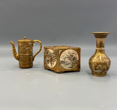 two vases and a teapot sitting next to each other on a table
