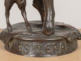 bronze statue of a man and a dog on a pedestal