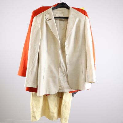 an image of a white jacket and yellow pants hanging on a hanger
