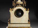 an antique clock with a marble base and a gold decoration
